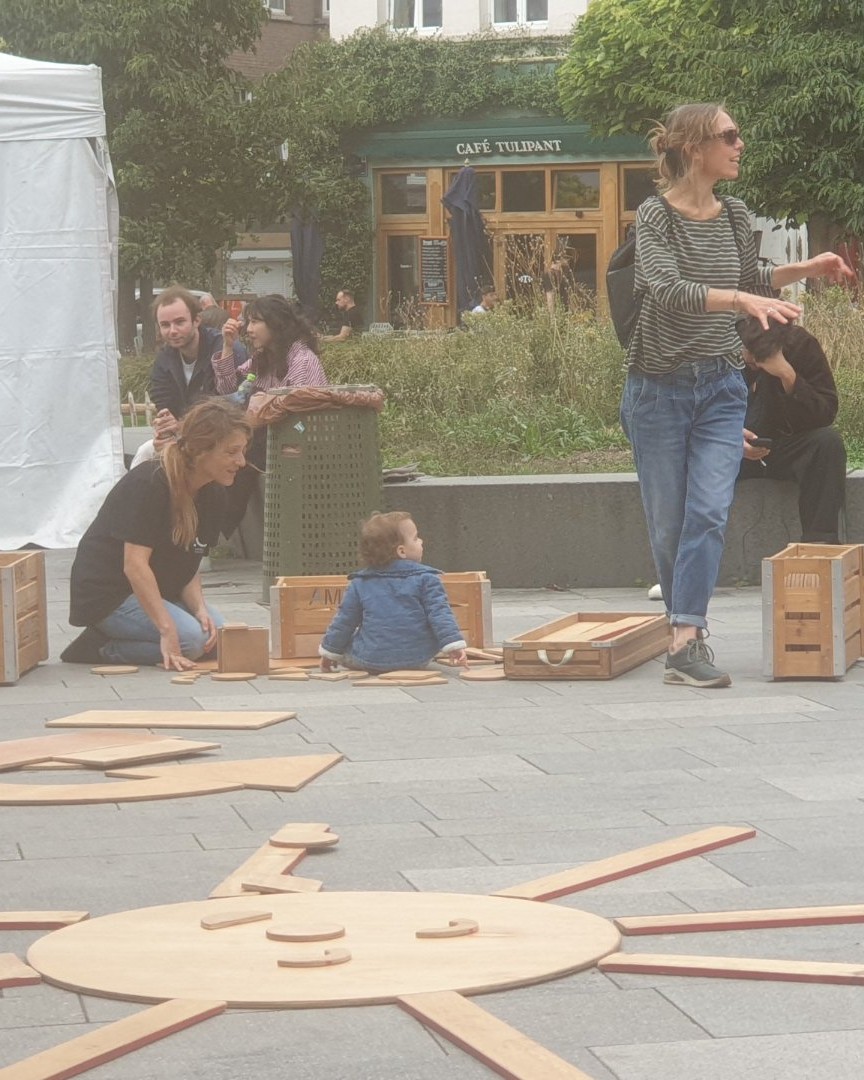 La grande réussite de l'événement organisé hier par KULT XL ? Avoir mis le public au cœur de l'œuvre ! Des tout-petits assemblant des pièces de bois sur le sol aux adultes se relaxant près des scénographies, tout invitait à la participation. J'ai adoré immortaliser cette belle énergie partagée au centre d'Ixelles.

Photographie — La Joyeuse Rentrée 2026 à Ixelles : Festival Culturel Gratuit à la Place Fernand Cocq